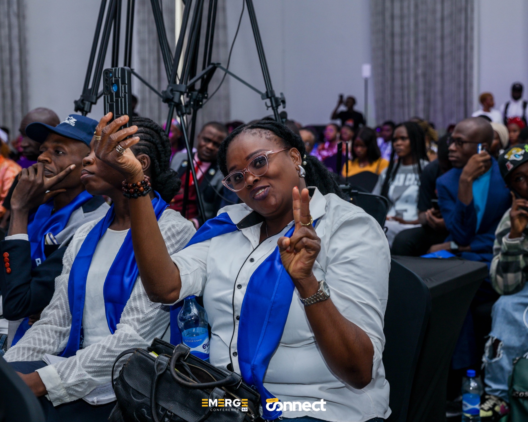 Attendee showing peace sign at the conference