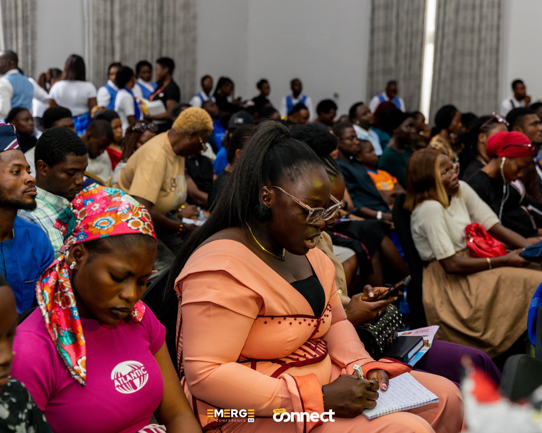 Audience members taking notes